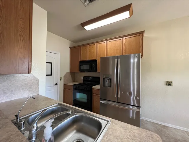a kitchen with a refrigerator sink and microwave