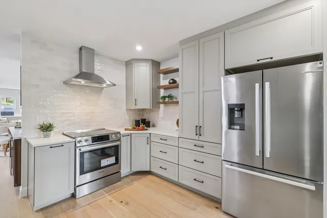 a kitchen with stainless steel appliances a refrigerator stove and sink