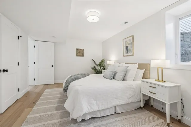 a bedroom with a bed and a night stand