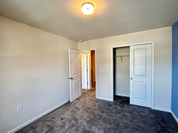 an empty room with closet area