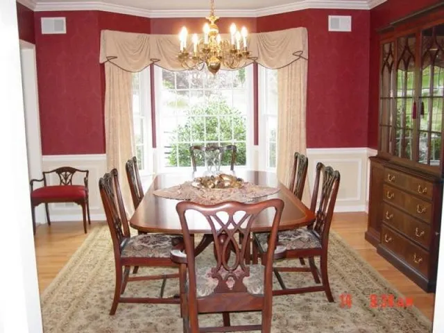 a view of a dining room with furniture and window