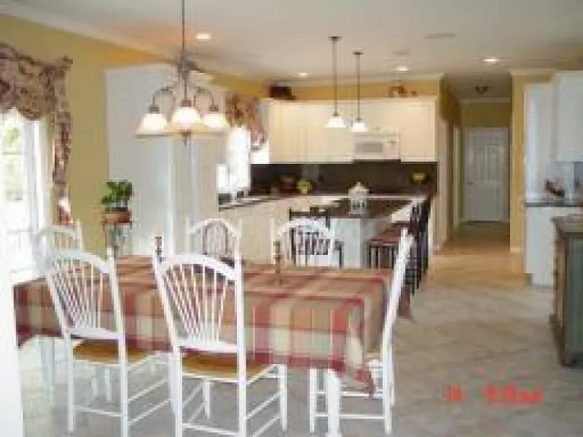 a large kitchen with a table and chairs