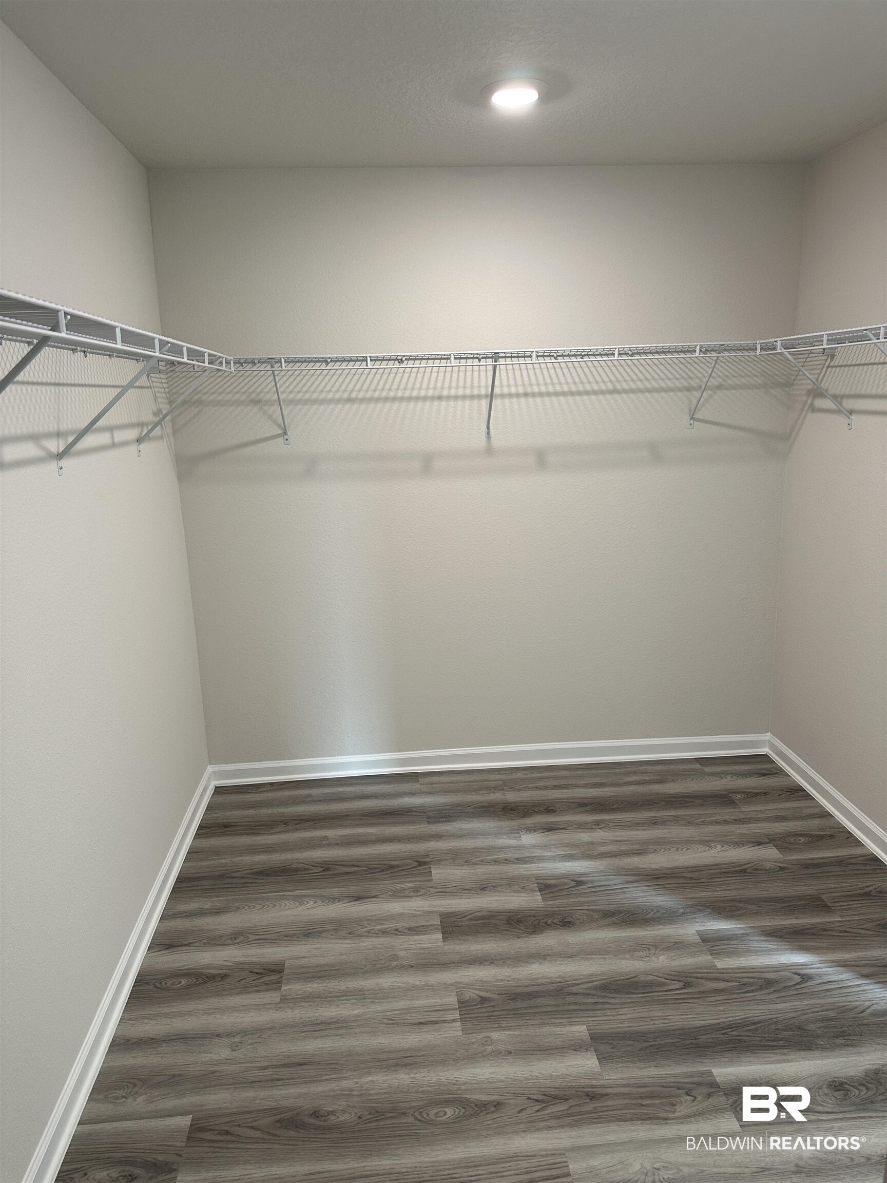 8850 Sea Star Circle Foley, AL 36535 - Photo 27 of 29 Walk in closet featuring dark hardwood / wood-style flooring