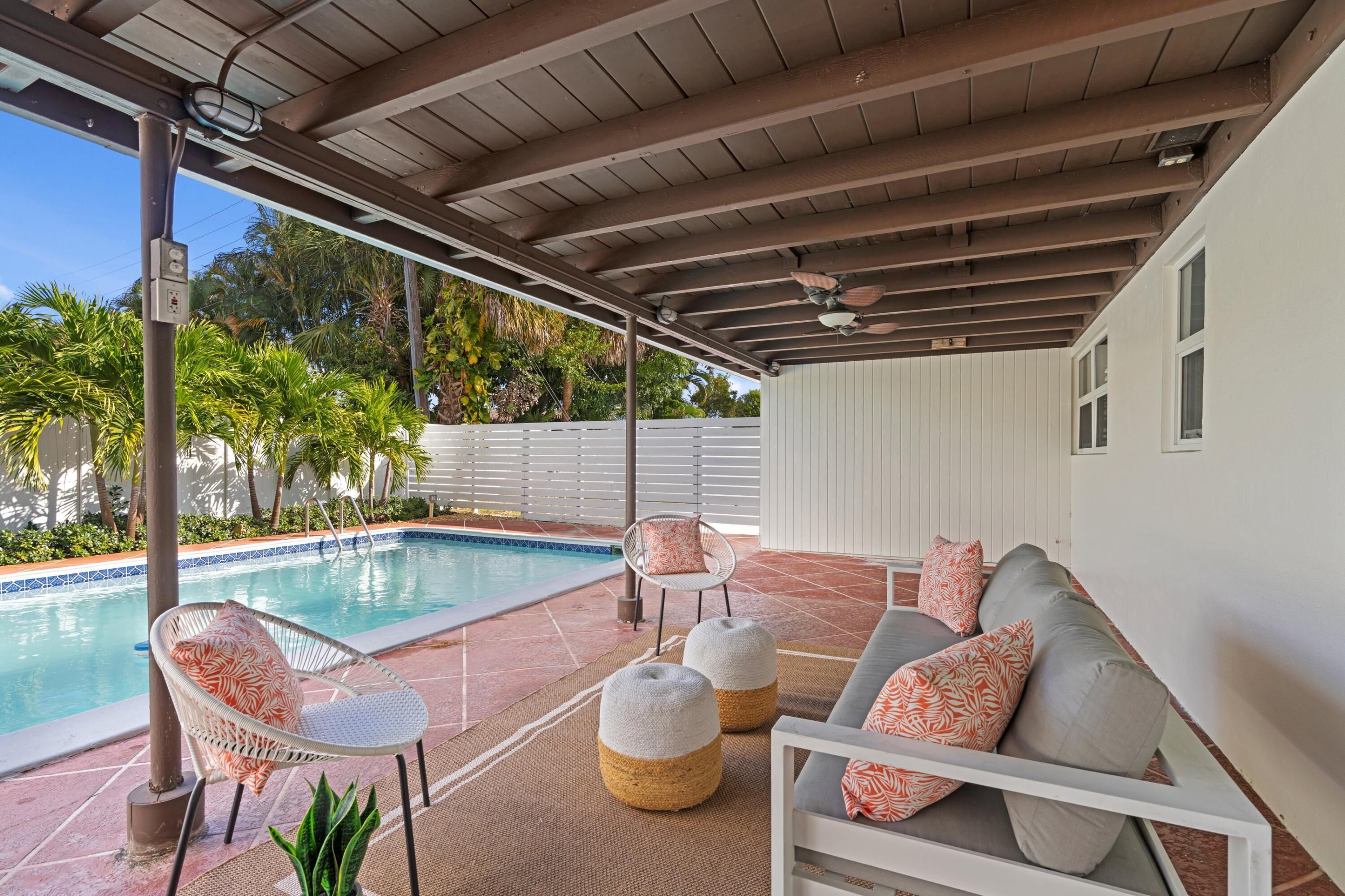 541 Kingfish Road North Palm Beach, FL 33408 - Photo 31 of 42 a patio with a table and chairs and potted plants