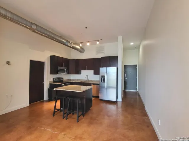 a kitchen with a table and chairs in it