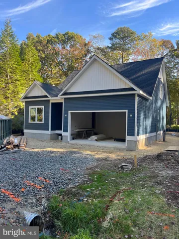 a front view of a house with a yard and mountain view