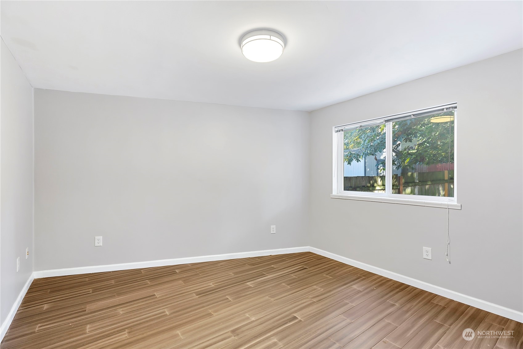 7209 6th Avenue West Everett, WA 98203 - Photo 16 of 27 a view of an empty room with wooden floor and a window