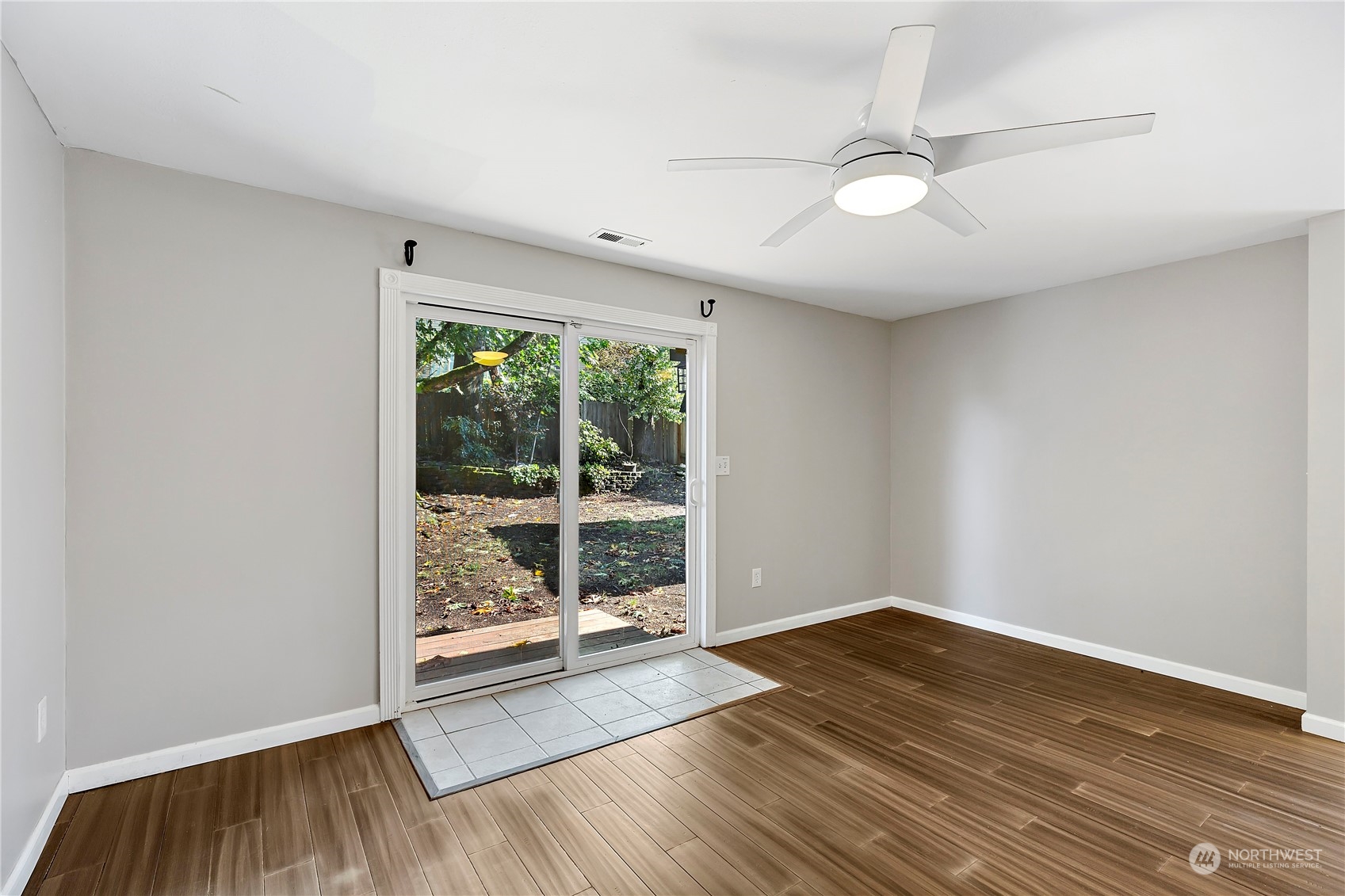 7209 6th Avenue West Everett, WA 98203 - Photo 18 of 27 an empty room with wooden floor fan and windows