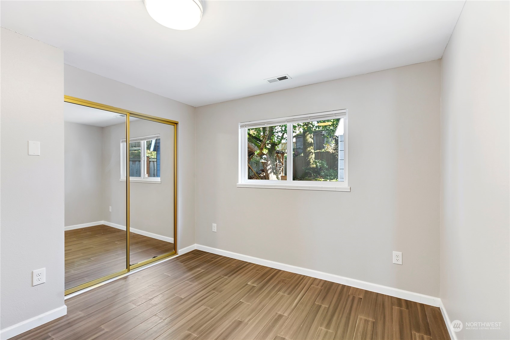 7209 6th Avenue West Everett, WA 98203 - Photo 19 of 27 an empty room with wooden floor and windows