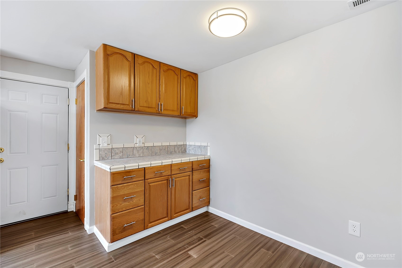 7209 6th Avenue West Everett, WA 98203 - Photo 7 of 27 a view of a kitchen with wooden floor and cabinets
