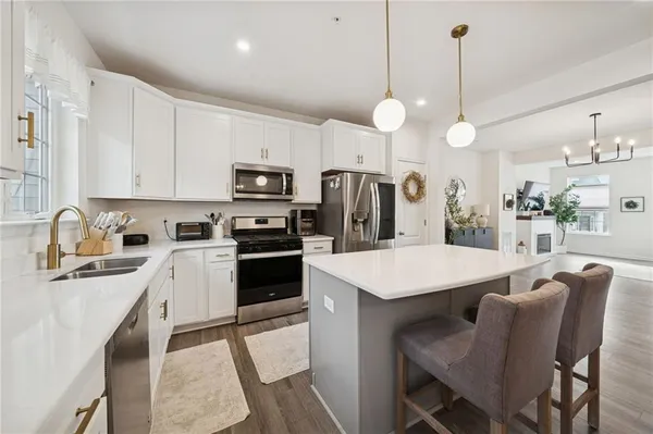a kitchen with cabinets a counter space appliances and cabinets