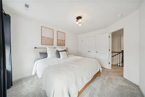 a bedroom with a bed and a large mirror