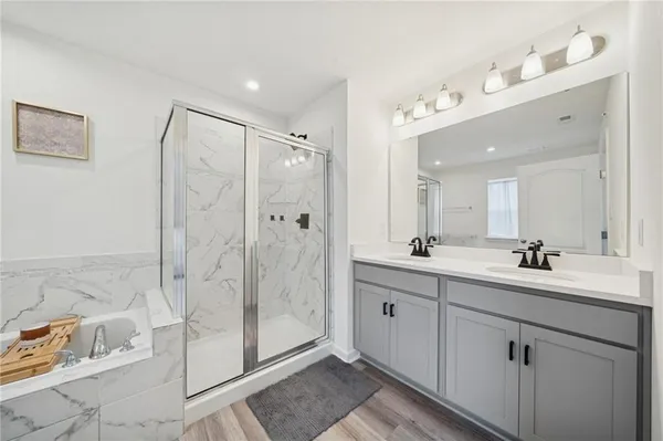 a bathroom with a double vanity sink mirror and shower