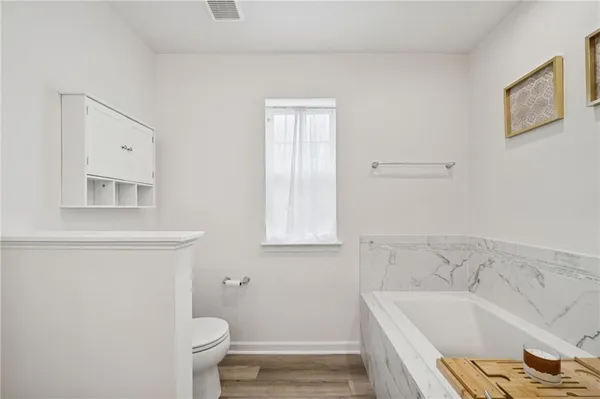 a bathroom with a sink a toilet and bathtub