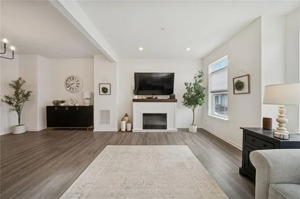 a living room with furniture a fireplace and a flat screen tv