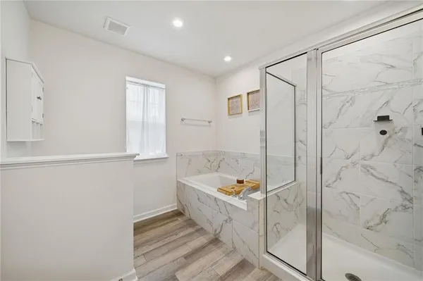 a bathroom with a tub and shower