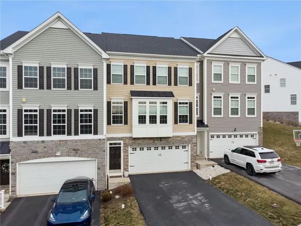 a car parked in front of a brick house