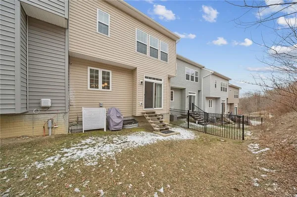 a view of a house with backyard and chairs