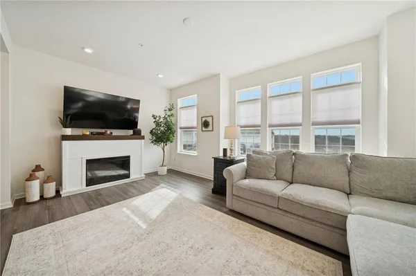 a living room with furniture a fireplace and a flat screen tv