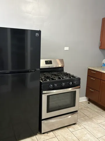 a stove top oven sitting inside of a kitchen