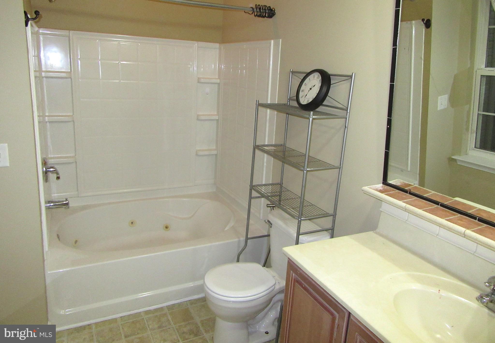 103 Persimmon Place Bear, DE 19701 - Photo 15 of 22 a bathroom with a granite countertop toilet a sink and bathtub