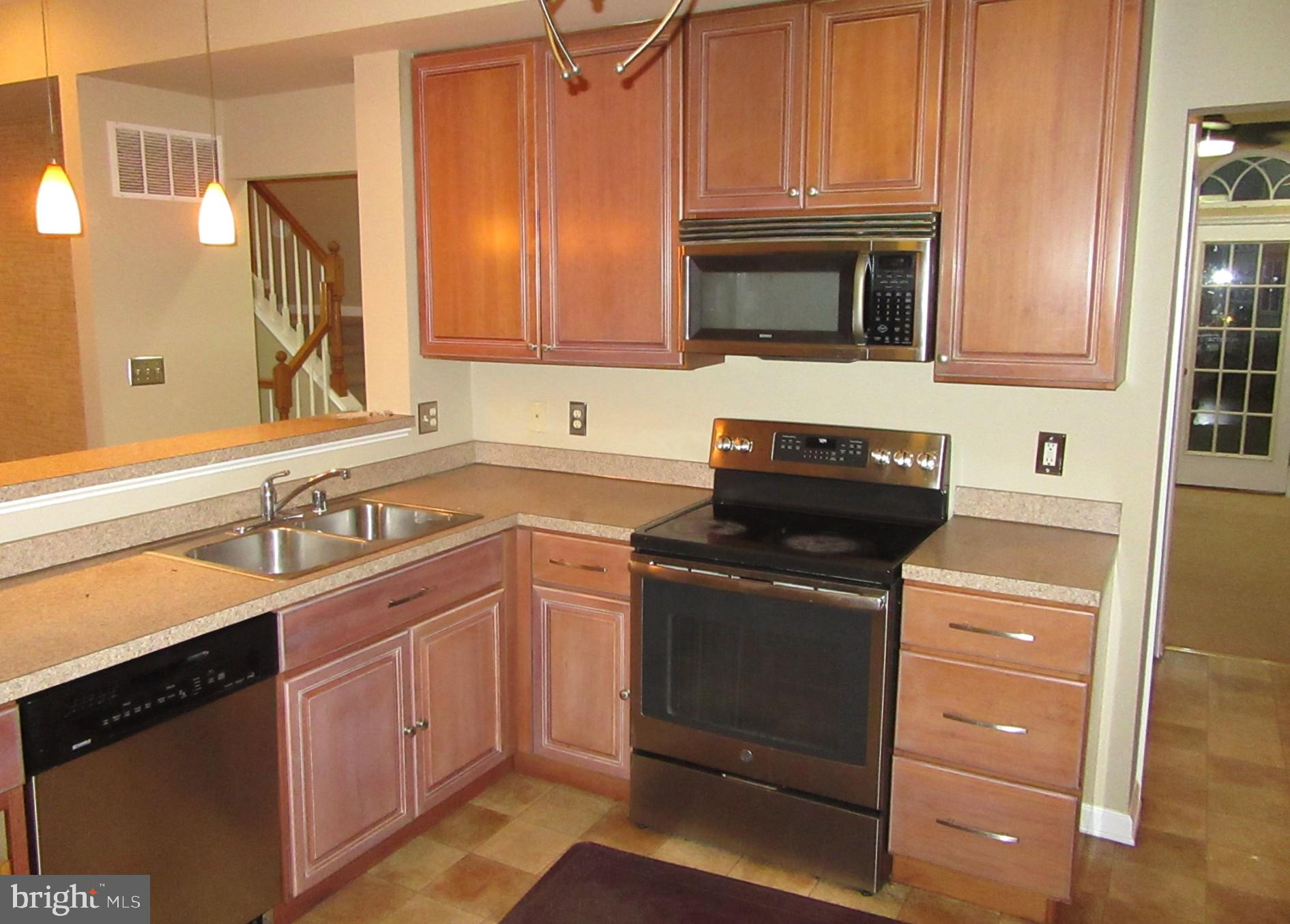 103 Persimmon Place Bear, DE 19701 - Photo 3 of 22 a kitchen with a sink stove and microwave