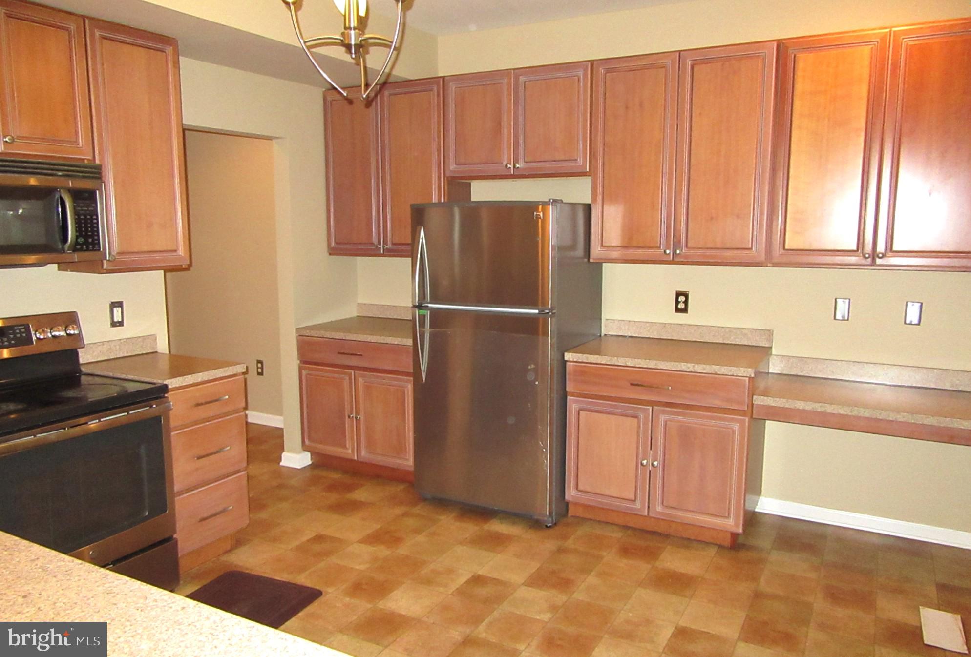 103 Persimmon Place Bear, DE 19701 - Photo 4 of 22 a kitchen with stainless steel appliances granite countertop a refrigerator sink and cabinets