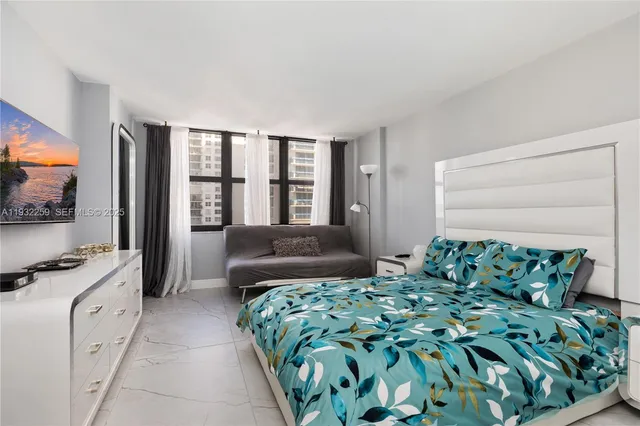 a bedroom with furniture and a flat screen tv