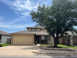 14909 Nuttall Drive Austin, TX 78724 - Photo 1 of 13 View of front facade featuring driveway and an attached garage