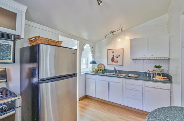 a kitchen with stainless steel appliances granite countertop a refrigerator sink and cabinets