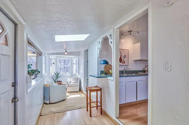 a kitchen with furniture a counter top space a sink stainless steel appliances and cabinets