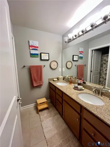 a bathroom with a sink double vanity and a mirror