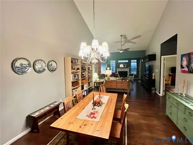 a view of a dining room with furniture and a chandelier
