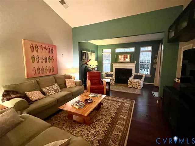 a living room with furniture fireplace and a table