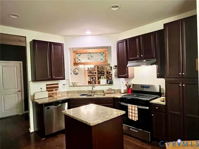 a kitchen with a sink stove and refrigerator