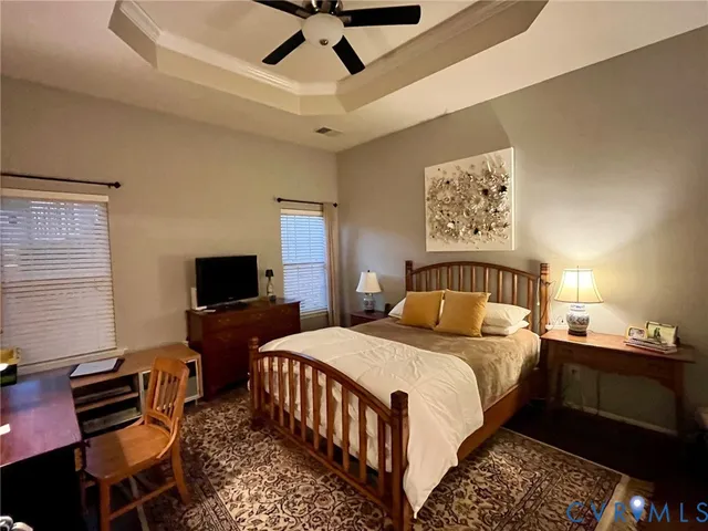 a bedroom with a bed and a tv