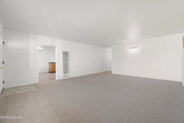 an empty room with windows and entrance