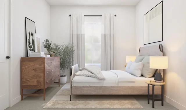 a bedroom with a bed a lamp and a large mirror