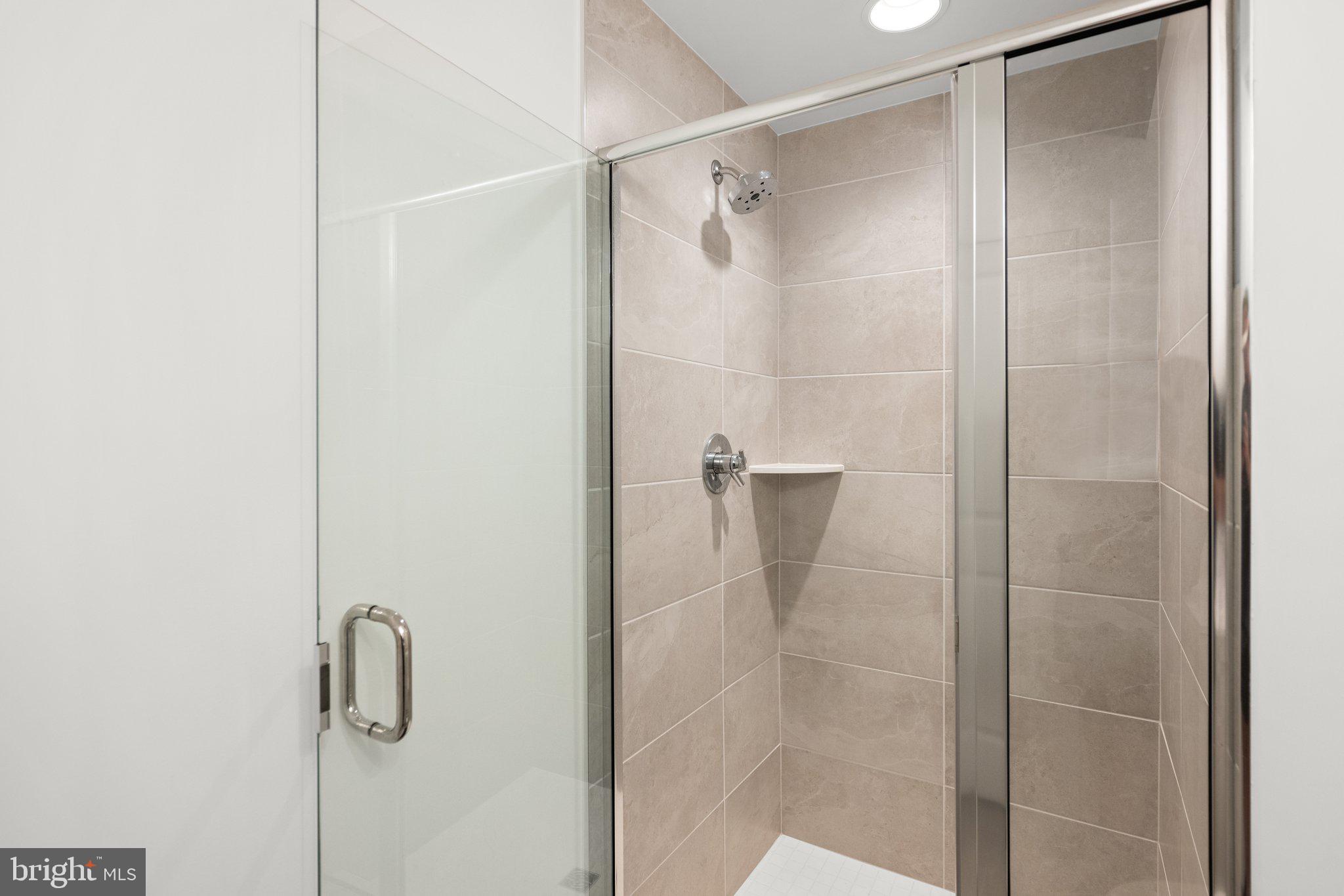 302 Alluvium Drive Laurel, MD 20724 - Photo 56 of 66 a bathroom with a glass shower door