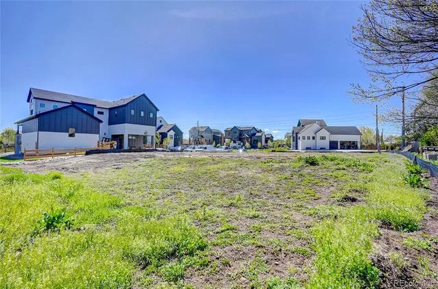 a view of dirt field with trees in background