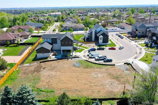 an aerial view of a house with a garden and mountain view