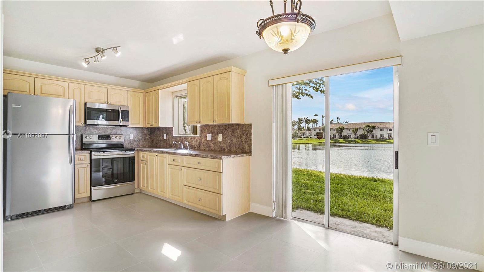 a kitchen with a stove a refrigerator and a sink