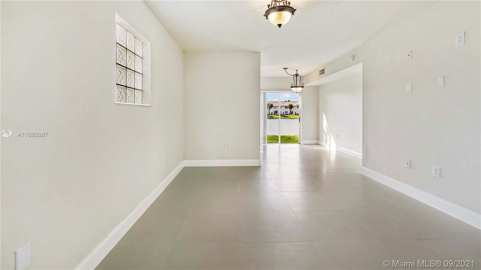 1270 Southeast 26th Street, Unit 101 Homestead, FL 33035 - Photo 3 of 12 a view of an empty room with a window