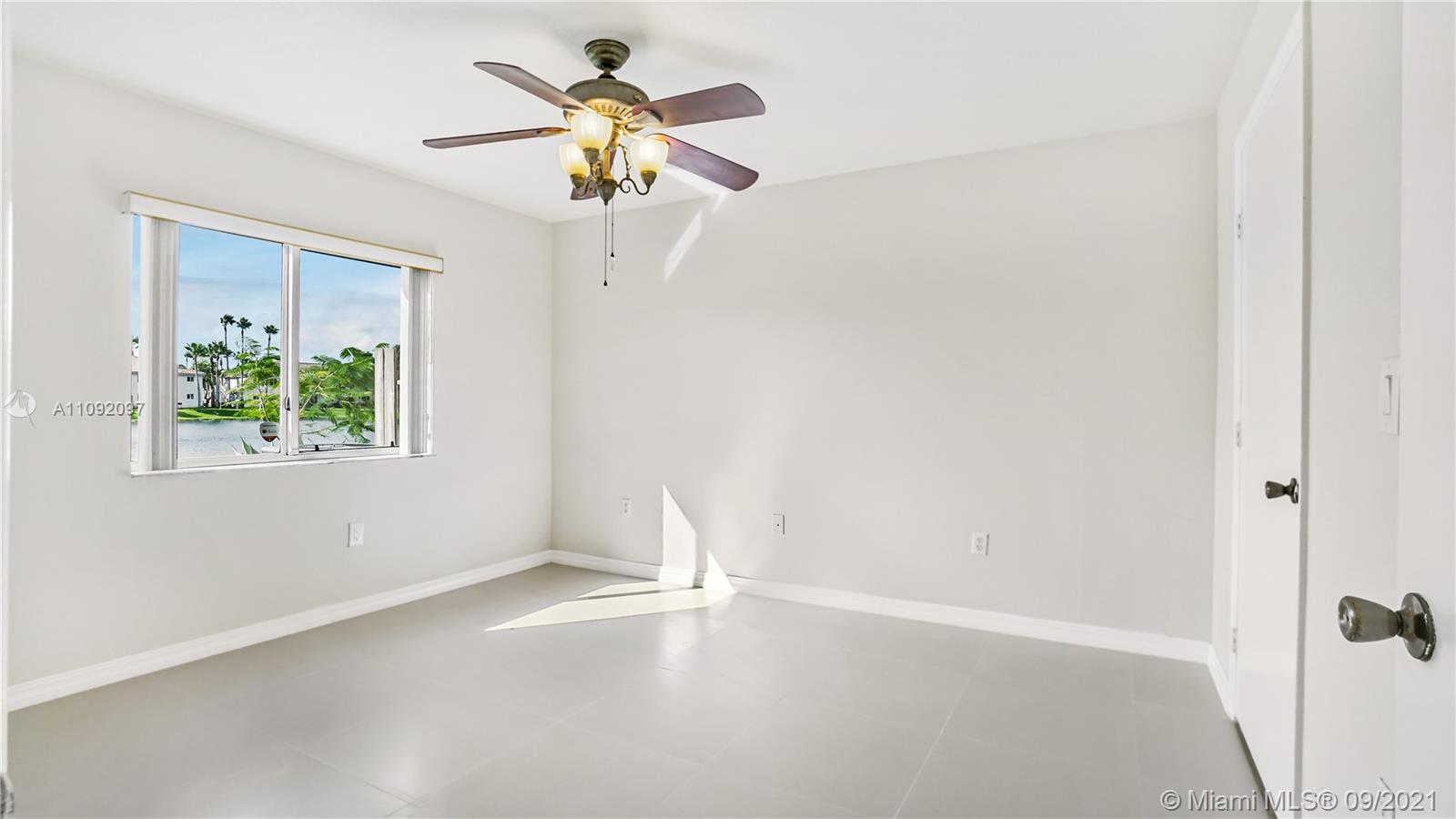 1270 Southeast 26th Street, Unit 101 Homestead, FL 33035 - Photo 4 of 12 an empty room with a window and a fan