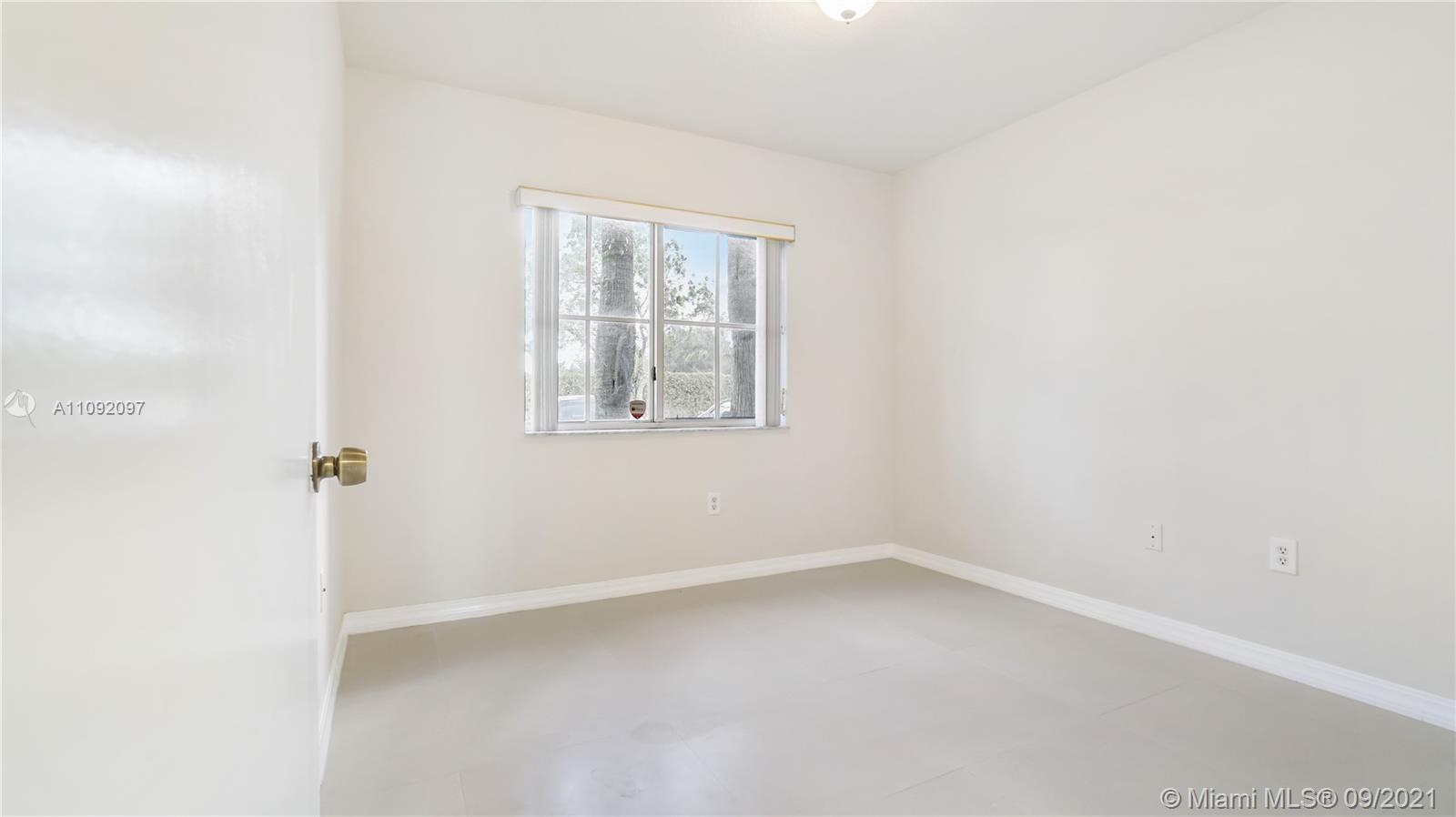 1270 Southeast 26th Street, Unit 101 Homestead, FL 33035 - Photo 7 of 12 an empty room with a window