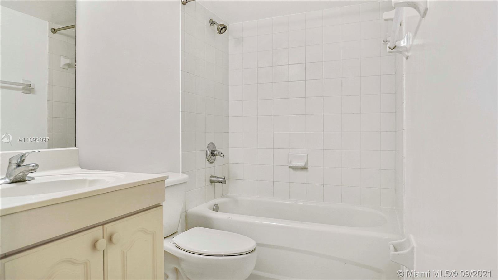 1270 Southeast 26th Street, Unit 101 Homestead, FL 33035 - Photo 8 of 12 a bathroom with a sink toilet and shower