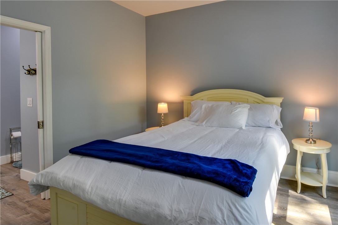 206 Petty Road Seneca, SC 29672 - Photo 24 of 48 A well-lit bedroom features sturdy hardwood flooring and convenient access to a private bathroom.