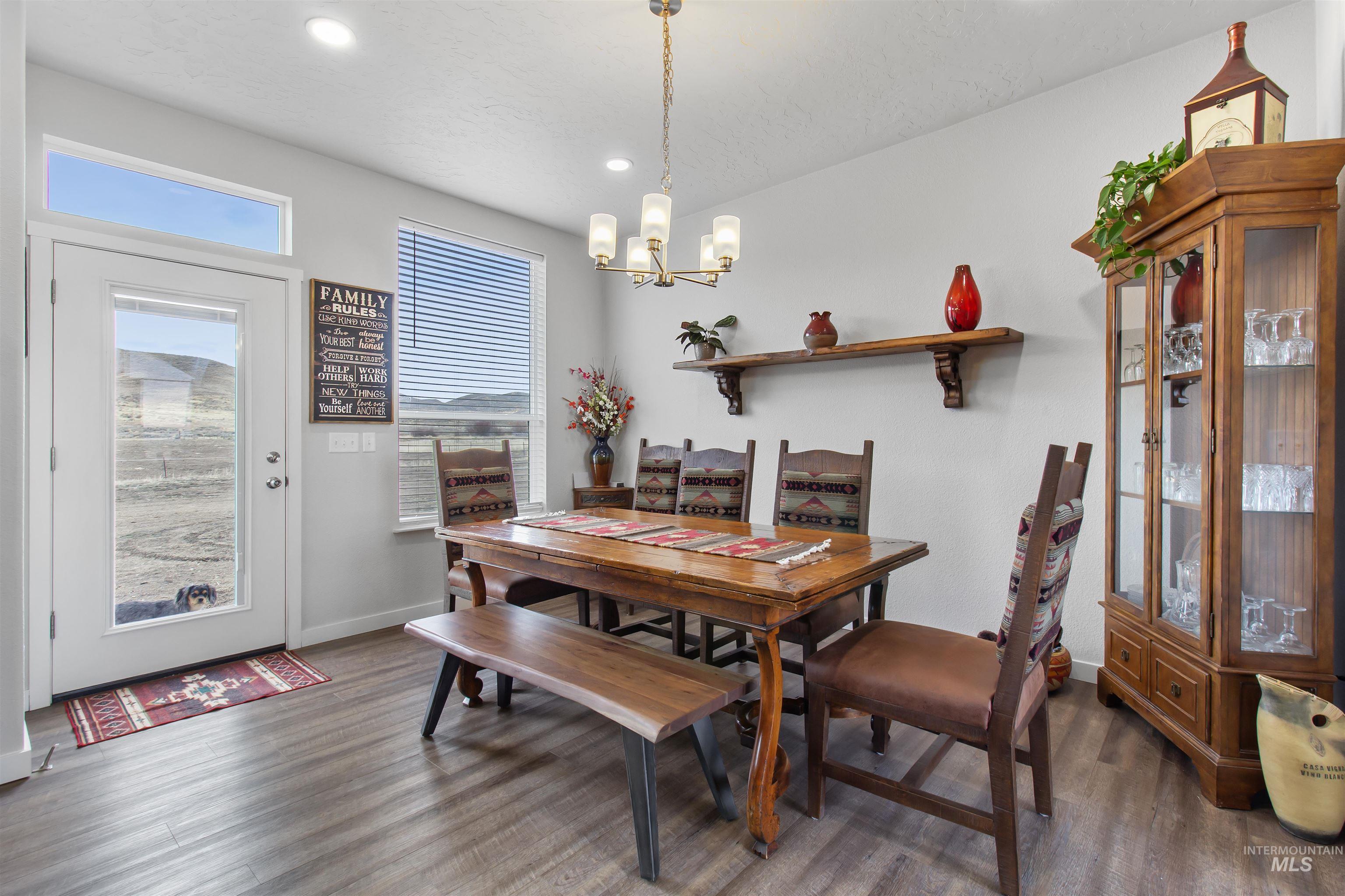 161 Horseshoe Loop West Fairfield, ID 83327 - Photo 12 of 50 Dining room featuring dark wood finished floors and suspended lighting
