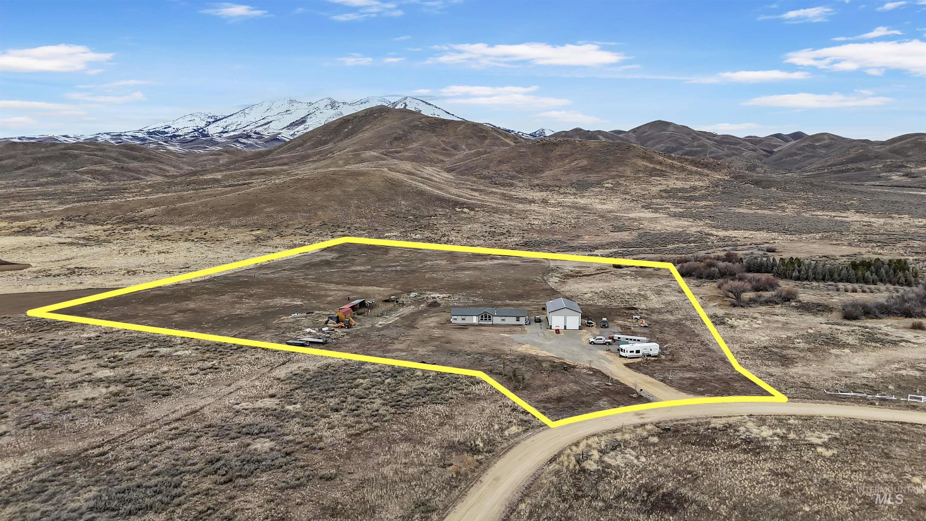 161 Horseshoe Loop West Fairfield, ID 83327 - Photo 2 of 50 Aerial view of sparsely populated area featuring property parcel outlined and mountains