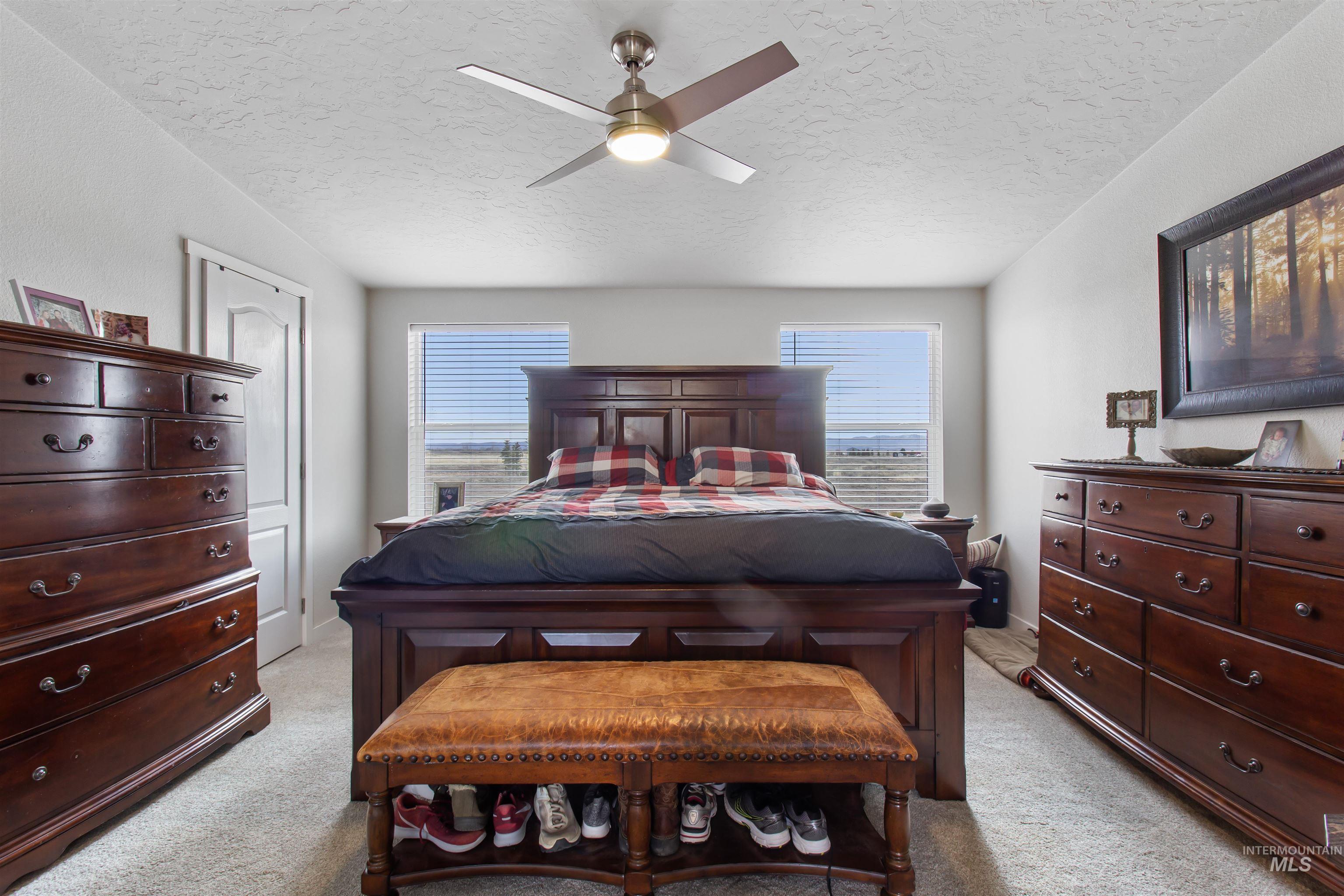 161 Horseshoe Loop West Fairfield, ID 83327 - Photo 27 of 50 Bedroom with a textured ceiling, a ceiling fan, and light carpet